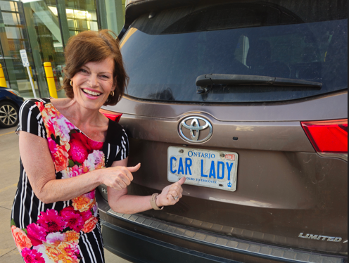 Christine posing with her Toyota Highlander