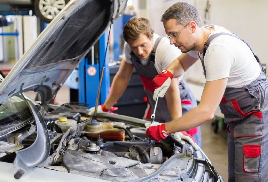 Mechanics repairing a car