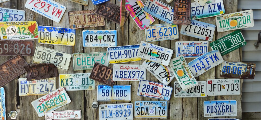 A wall with various license plates from across the USA