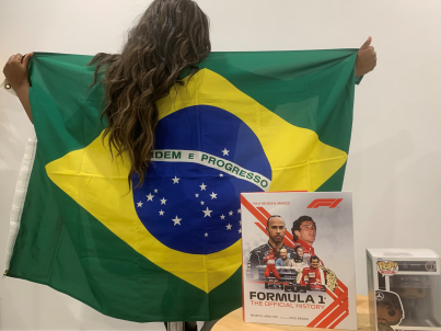 Deidra Clarke posing with F1 Paraphernalia