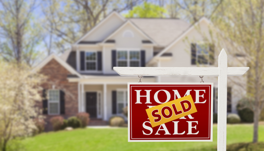 A sold sign in front of a house.