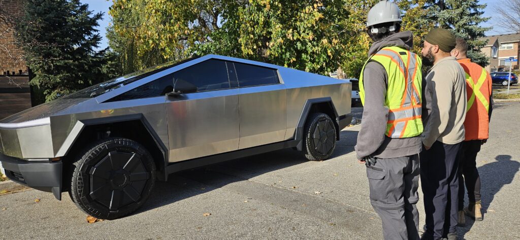 Construction workers admiring the Tesla Cybertruck