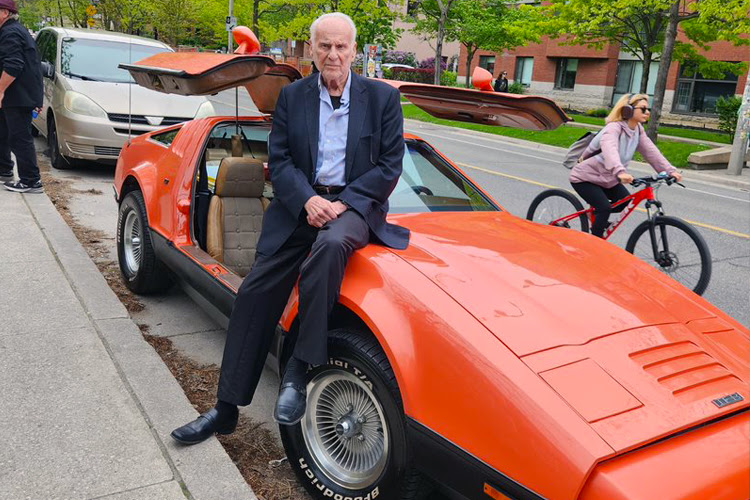 Malcolm Bricklin sitting on a Bricklin SV1