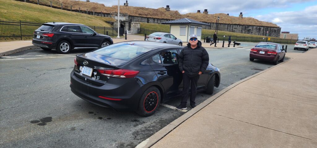 Tim German standing with his Hyundai Elantra at Halifax Citadel National Historic Site