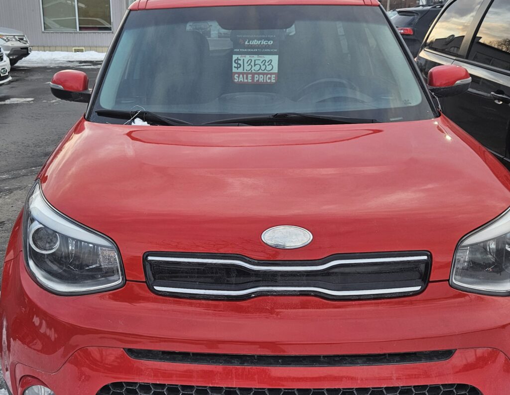 A Red Kia Soul on a Used Car Lot