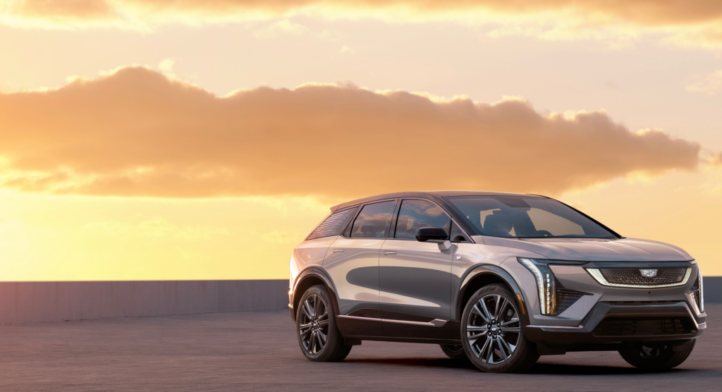 Front 3/4 view of 2025 Cadillac OPTIQ in Argent Silver Metallic.