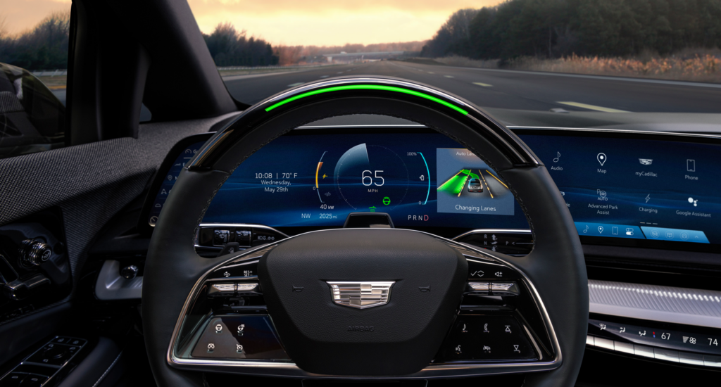 View of the 2025 Cadillac OPTIQ steering wheel with standard Super Cruise and steering wheel light bar activated.