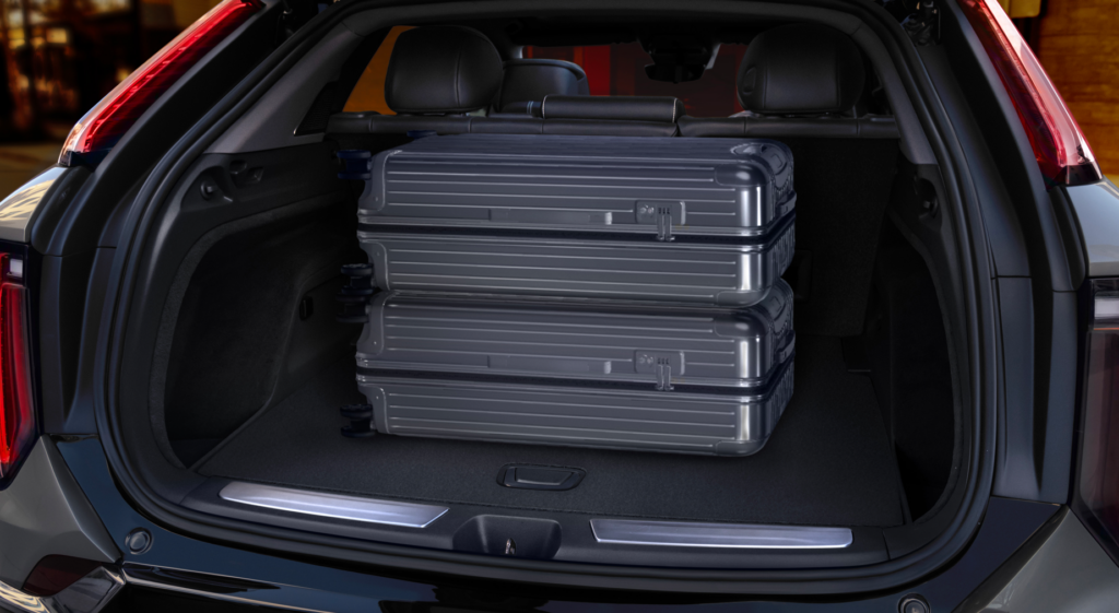 View of the 2025 Cadillac OPTIQ rear cargo area with the rear hatch opened, showing its segment-best cargo capacity.