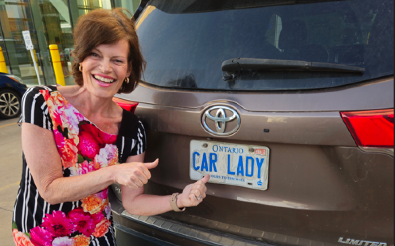 Christine posing with her Toyota Highlander