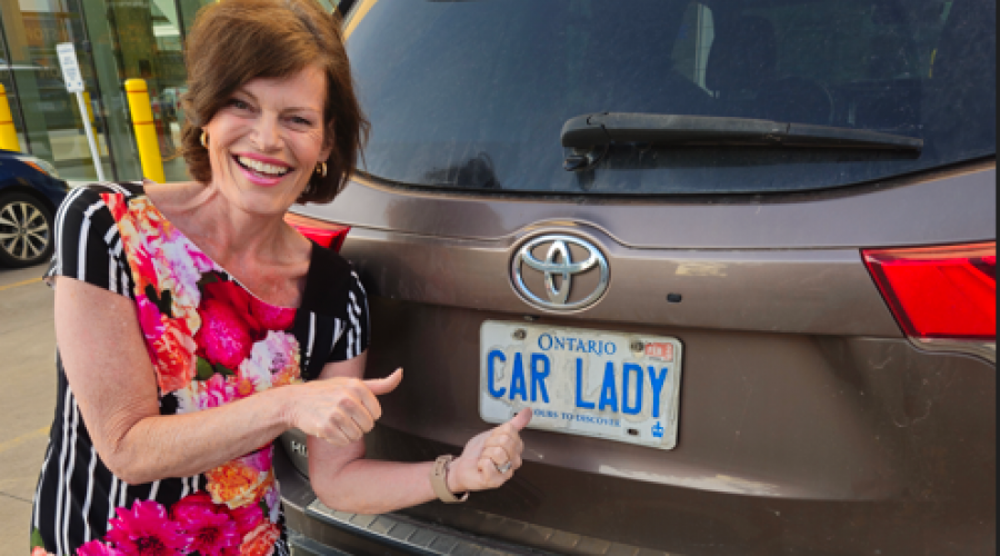 Christine posing with her Toyota Highlander