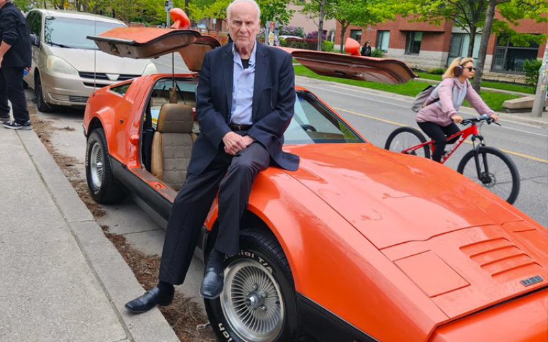 Malcolm Bricklin sitting on a Bricklin SV1