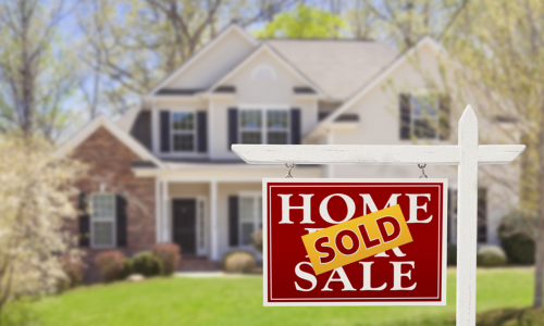 A sold sign in front of a house.