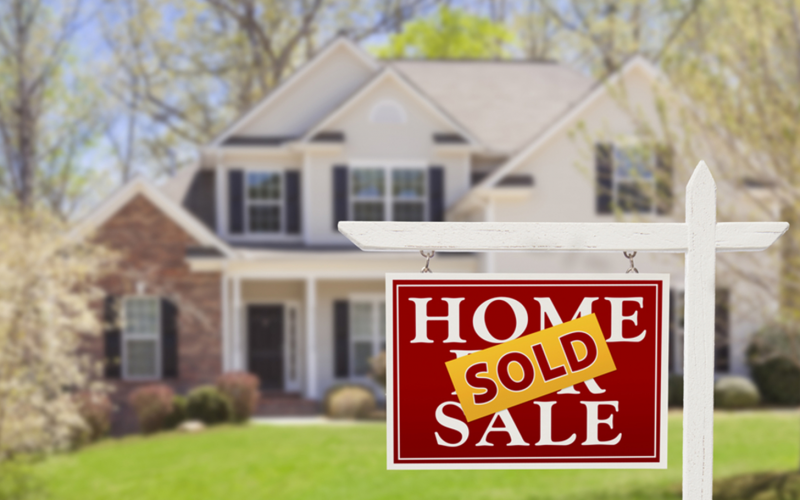 A sold sign in front of a house.