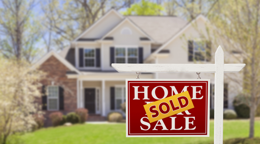 A sold sign in front of a house.