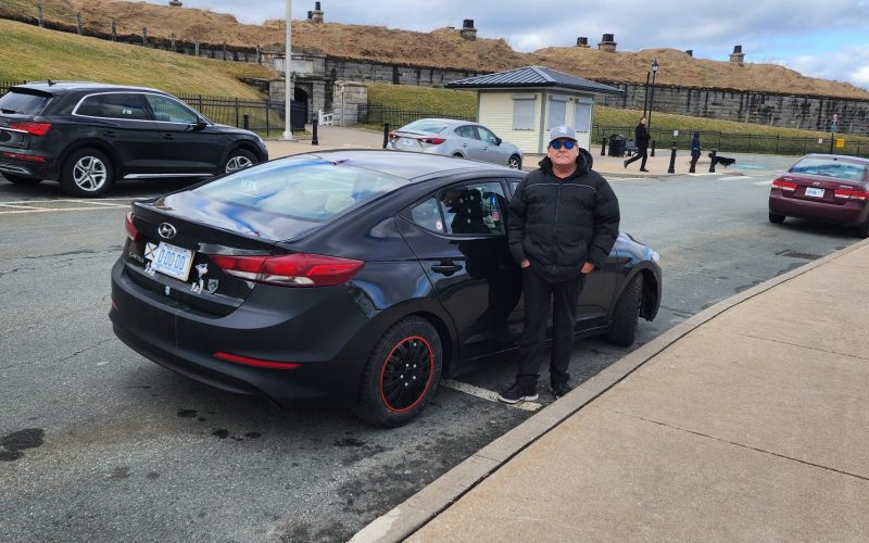 Tim German standing with his Hyundai Elantra at Halifax Citadel National Historic Site